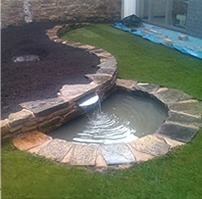 Garden water feature with cascade installed by Willow Landscapes